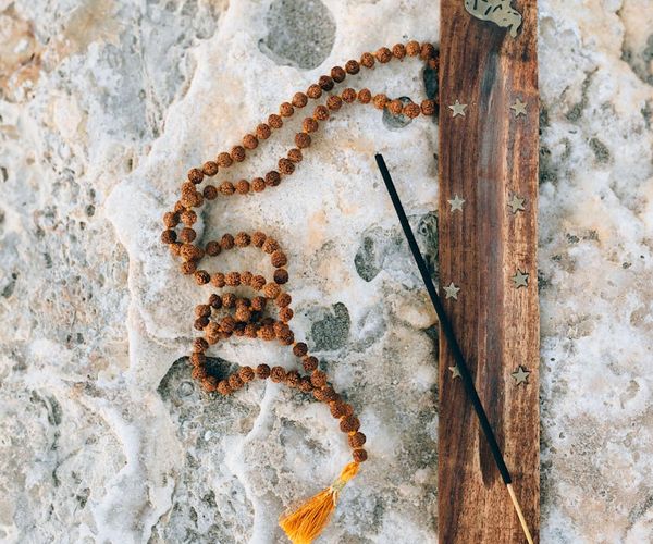 Silhouette of a person stretching against a warm, serene background.